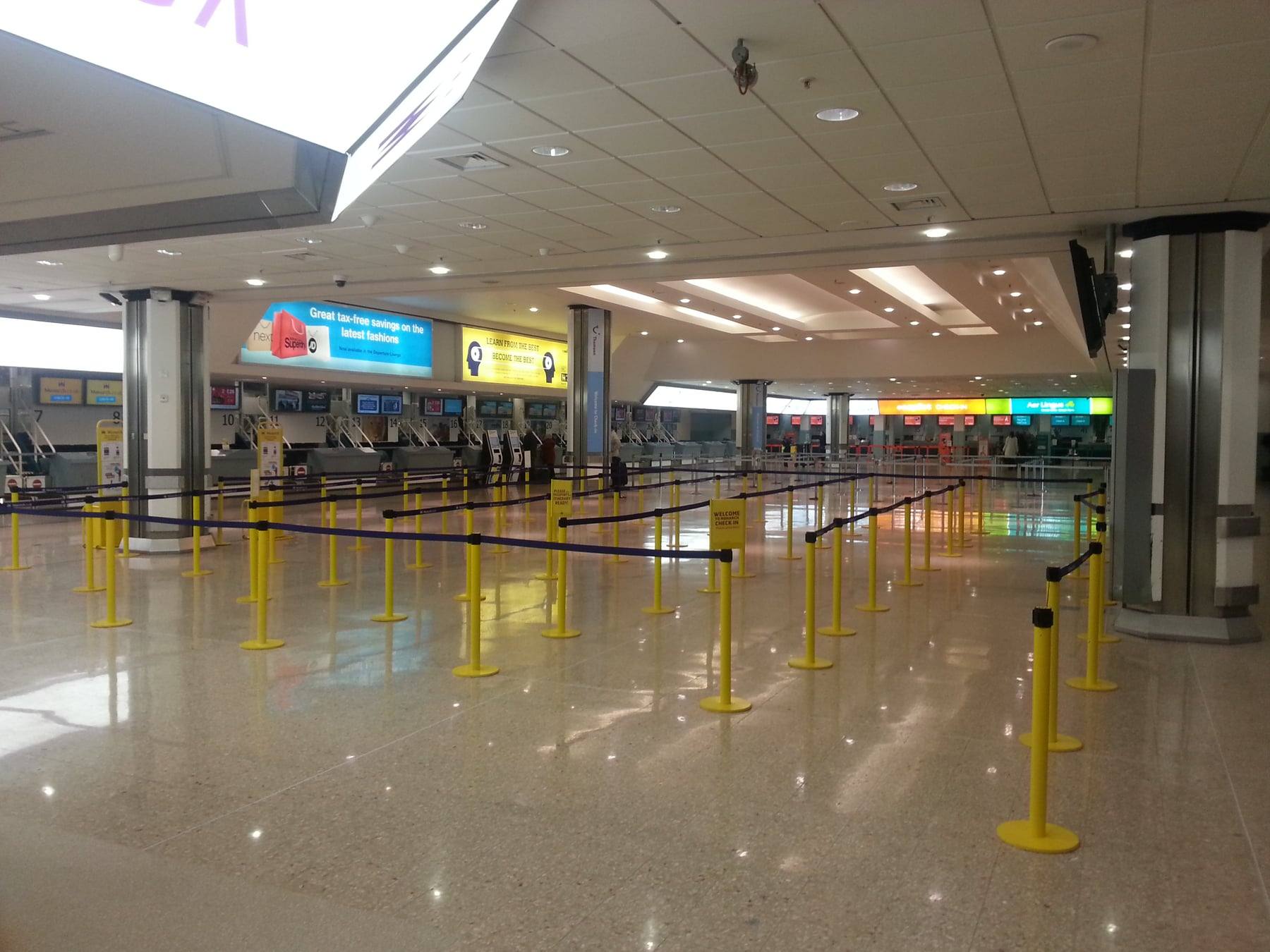 The check-in hall at Birmingham Airport, with queue lanes and check-in desks