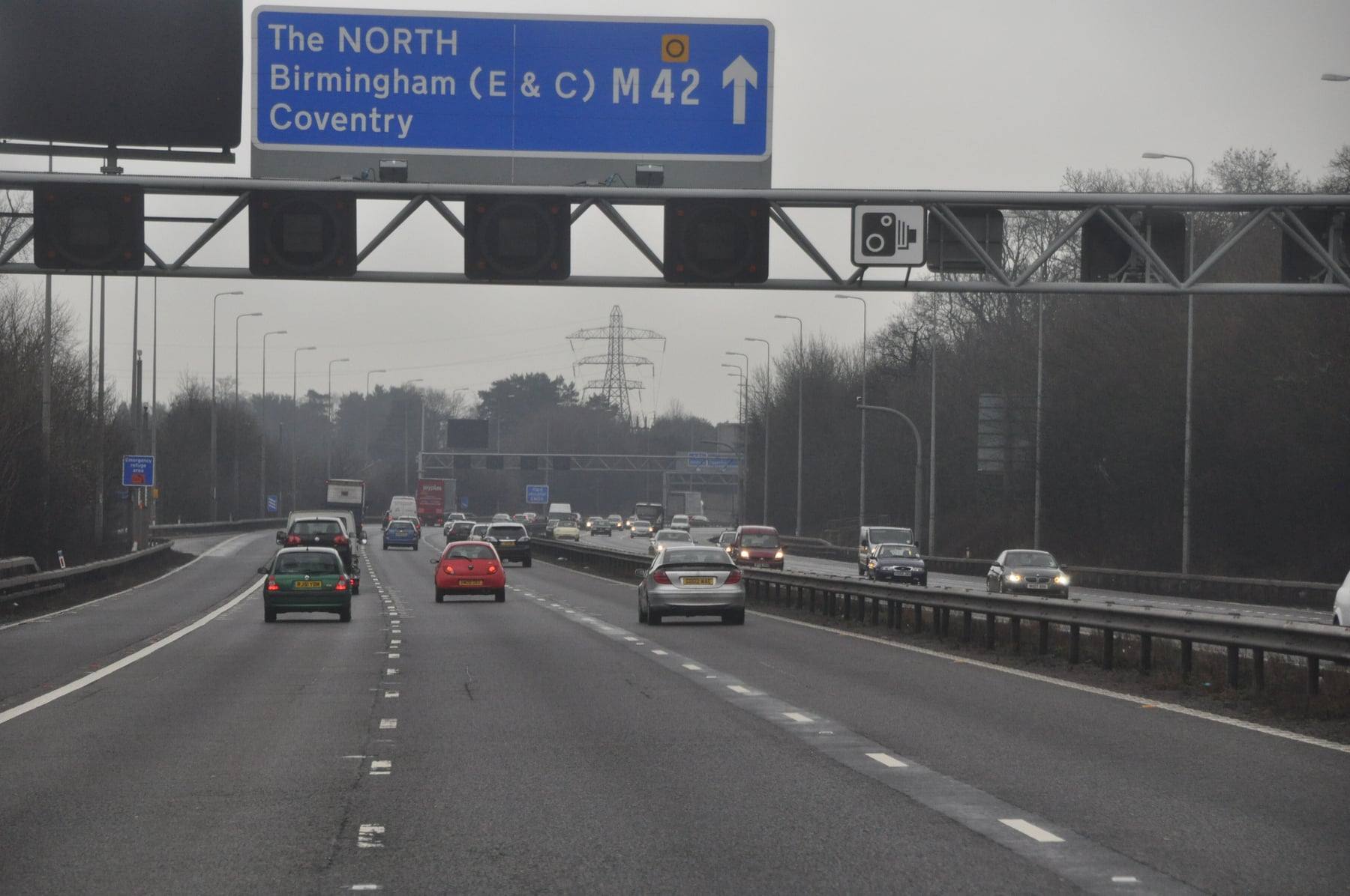 Overhead direction signs on the M42 motorway near Birmingham Airport, pointing to Birmingham and Coventry