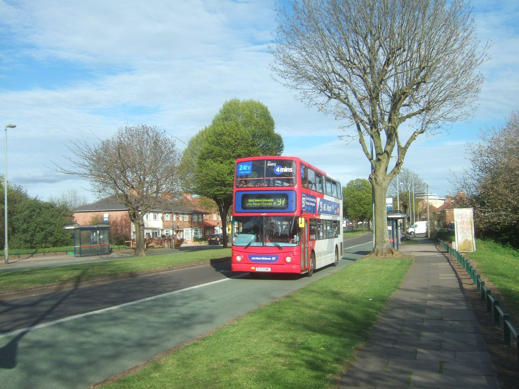A red National Express West Midlands double-decker bus on a Birmingham route