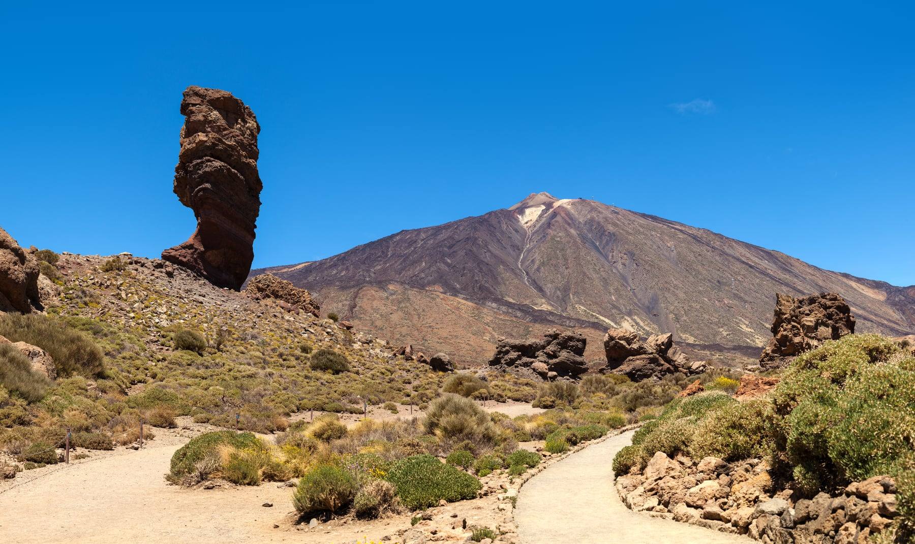 Mount Teide rising behind the Roque Cinchado rock formation on Tenerife